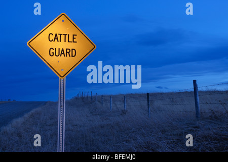 Pascoli e "i bovini di guardia' cartello stradale vicino Cochrane, Alberta, Canada Foto Stock