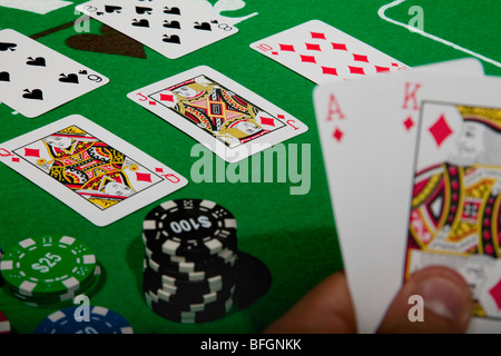Un giovane maschio giocatore al gioco d'azzardo con una mano vincente tabella modello di rilascio disponibili Foto Stock