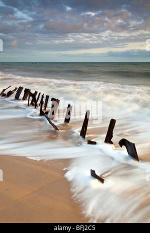 Abbandonate le difese del mare alla prima luce a Happisburgh sulla costa di Norfolk Foto Stock