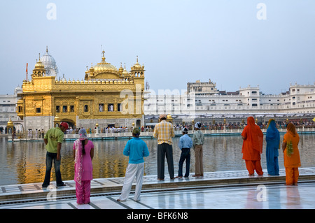 Pellegrini Sikh contemplando il Tempio Dorato. Amritsar. Il Punjab. India Foto Stock