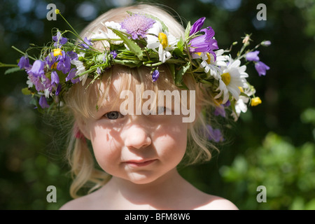 Grave bambina di fiori corona sul prato verde Foto Stock