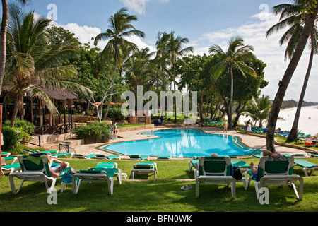 Kenya Mombasa. La piscina di Baobab Resort con le bianche sabbie della spiaggia di Diani in background. Foto Stock