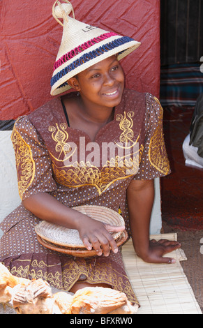 Tradizionalmente condita hat marcia Basotho (Sotho) adulto giovane ragazza seduta sul terreno, villaggio Lesedi Sud Africa, Novembre 2009 Foto Stock