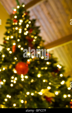 Guardando verso l'alto un de-focalizzata, albero di Natale illuminato. Foto Stock