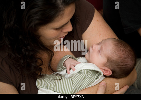 Un bianco madre detiene il suo sonno uno mese-vecchio figlio bambino Foto Stock