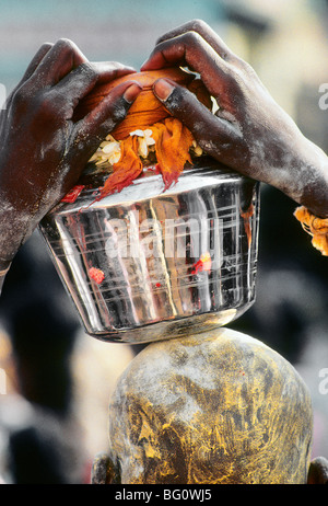 Un pellegrino/devoto porta un'offerta all'Palani Murugan Temple e sta prendendo parte al festival di Thaipusam per onorare il Signore Subramaniam (noto anche come Signore Muruga), figlio di Shiva. L'offerta bilanciata sulla sua testa è una forma di kavadi e simboleggia l'onere che egli porta per mostrare la sua devozione. Migliaia di indù come questo uomo venuto a cercare la penitenza e assoluzione per i peccati passati e mostrare gratitudine a Dio per le benedizioni durante l'anno Foto Stock