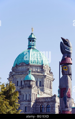 Il totem pole davanti a edifici del Parlamento, Victoria, Isola di Vancouver, British Columbia, Canada, America del Nord Foto Stock