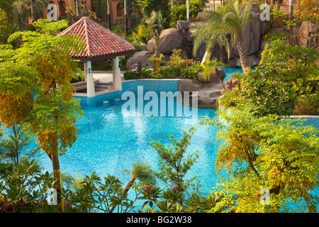 La piscina e gli alberi del giardino in un nuovo quartiere residenziale Foto Stock