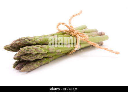 Gli asparagi spears legato di canapa o di sisal string mantenendole ordinate isolata contro il bianco. Foto Stock