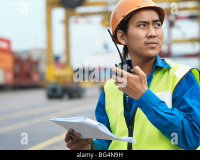 Un uomo sul lavoro, parlando in una radio. Foto Stock