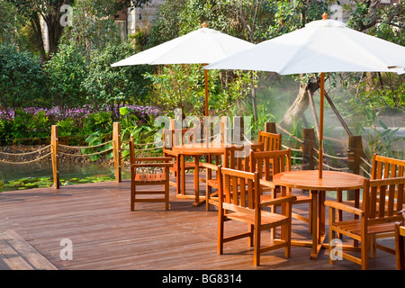 Casa patio con tavolo e sedie sotto ombrellone Foto Stock