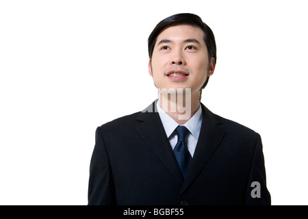 Imprenditore in abito scuro su sfondo chiaro Foto Stock