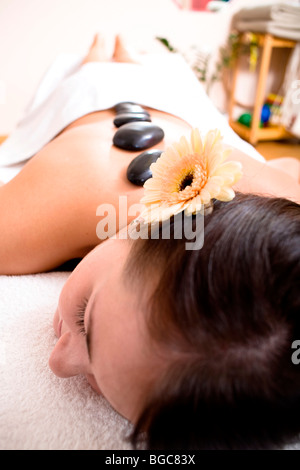 Paziente in una pratica di fisioterapia ottenendo un massaggio Hot Stone Foto Stock