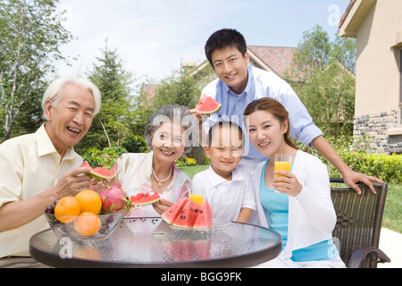 Tre generazioni la famiglia mangiare anguria Foto Stock