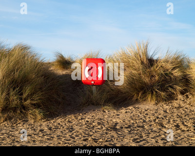 Un rosso brillante salvagente sulla spiaggia a Aberdovey (Aberdyfi), Gwynedd Mid Wales UK Foto Stock