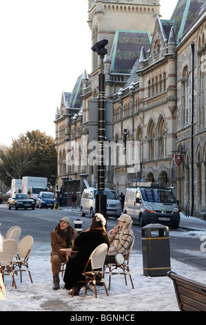 Le persone che hanno preso una pausa dal lottando attraverso la neve in Winchester High Street, Hampshire, Inghilterra. Foto Stock