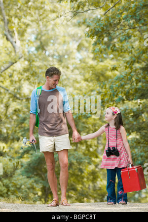 Uomo maturo in piedi con la mano della figlia Foto Stock