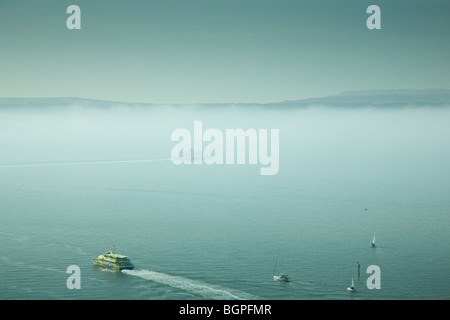 Traghetti e imbarcazioni al di fuori del porto di Portsmouth con la nebbia copriva Isle of Wight in background, da Spinnaker Tower. Foto Stock