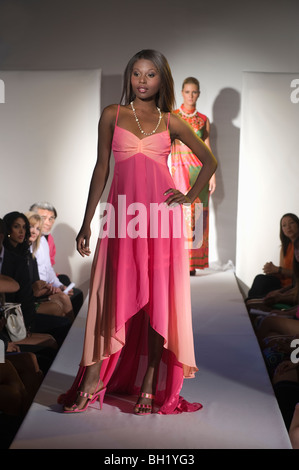 Donna in abito rosa sulla passerella per sfilate di moda Foto Stock