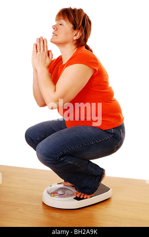 Pregando per la perdita di peso Foto Stock