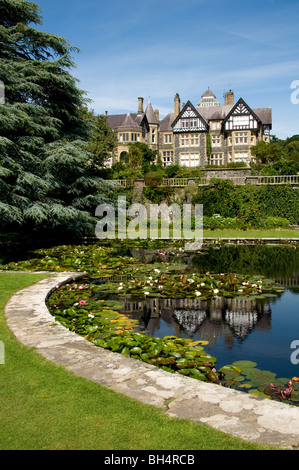 Vista panoramica di Bodnant la casa e il giardino con la riflessione di casa a lily pond. Foto Stock