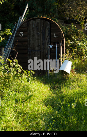 Il vecchio Anderson Shelter essendo utilizzato come un capannone in un riparto plot. Foto Stock