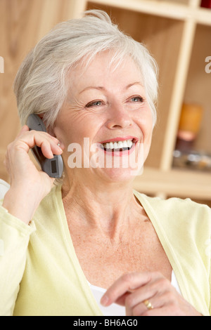 Senior donna usando il telefono di casa Foto Stock
