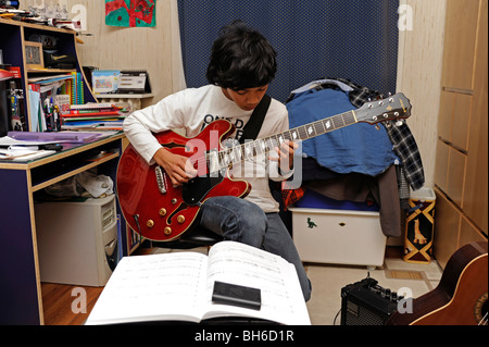 Ragazzo giocare con un aria di chitarra jazz, stile Gibson 335 Foto Stock