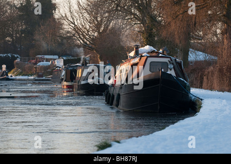 Strette barche ormeggiate sulla congelati Llangollen Canal in inverno a Ellesmere, Shropshire, Inghilterra, Regno Unito Foto Stock