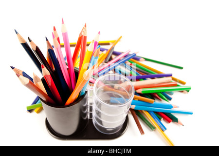 Studio shot di matite colorate in un portamatite di tazza più altri molti matite intorno Foto Stock