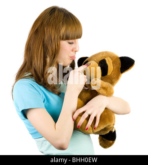 Bella bionda adolescente tenendo un orsacchiotto Foto Stock