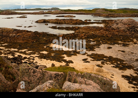 Vista della spiaggia di Fionnphort sul lato occidentale dell'isola di Mull nel nord ovest della Scozia con rocce in primo piano Foto Stock