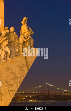 Portogallo Lisbona monumento alle scoperte e ponte di sospensione al crepuscolo Foto Stock
