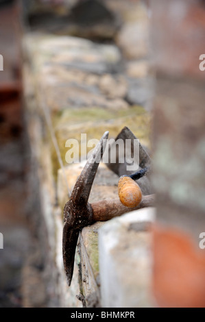 La costruzione di un muro del giardino con cotswold in pietra e malta di cemento nel Regno Unito Foto Stock