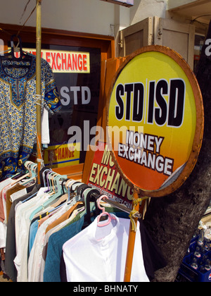 India Kerala, Kovalam, Faro (ADAM) spiaggia, lo scambio di denaro al di fuori del segno lungomare negozio di abbigliamento Foto Stock