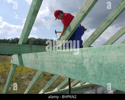 Carpenter il pilotaggio di un chiodo in casa puntone fascio di framing Foto Stock