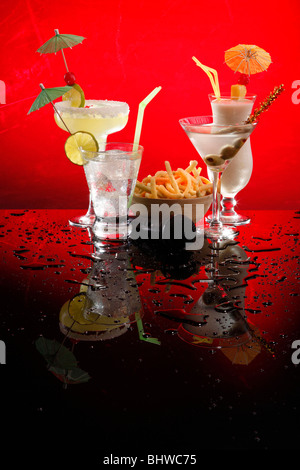 Bevande bianco su rosso, Martini, Margarita, Fizz e Colada con patatine e un karaoke mike Foto Stock