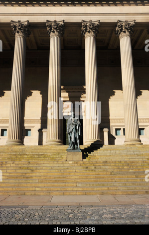 La statua di Benjamin Disraeli, Conte di Beaconsfield, sorge nella parte anteriore del St Georges Hall, un edificio neoclassico di calce Stre Foto Stock