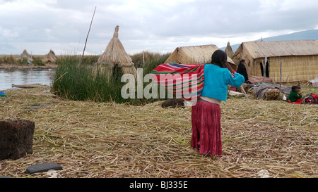 Il Perù Uros isole galleggianti offshore da Puno, il lago Titicaca. Indiani Uros che vivono su l'uomo fatto di isole galleggianti. Foto Stock