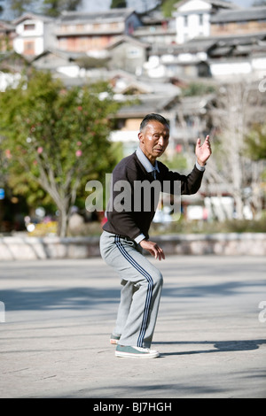 L'uomo praticare il tai chi in mattina presto nella cittadina turistica di Lijiang, nella provincia dello Yunnan in Cina. Foto Stock