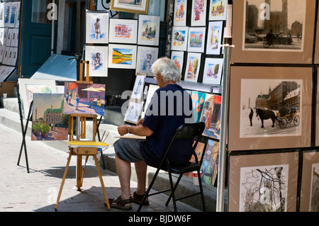 Un artista al lavoro nel vecchio quartiere del centro cittadino di Montreal in Quebec, Canada Foto Stock