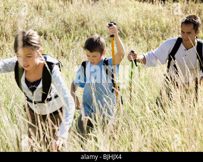 Padre escursionismo con i suoi due bambini Foto Stock