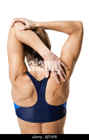Donna atleta raggiungendo per la schiena Foto Stock