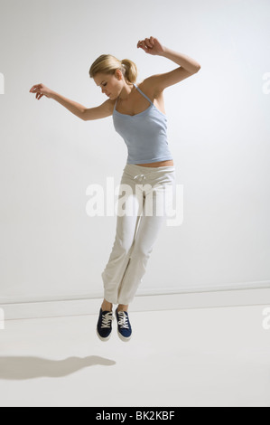 Bellezza femminile saltando in studio Foto Stock