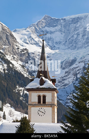 Neve e ghiaccio coperto montagne sopra la chiesa del villaggio di Grindelwald, regione di Jungfrau, Oberland bernese, Alpi Svizzere Foto Stock