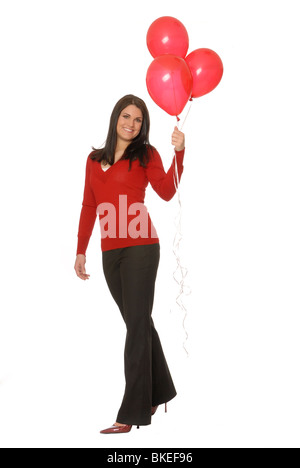 Donna attraente con tre palloncini rossi. Foto Stock