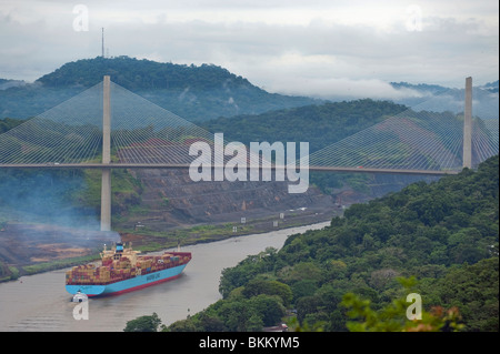 Un contenitore nave passando Gaillard Cut e in procinto di passare sotto il ponte del Centenario, il canale di Panama, Panama Foto Stock