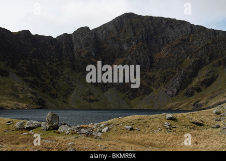 Il lago di Llyn Cau accoccolato sotto la grande scogliera di Craig Cau sulla montagna di Cadair Idris in Snowdonia, il Galles del Nord Foto Stock