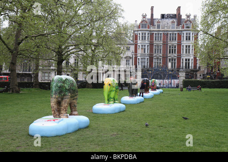 Fila di decorate famiglia Elephant Parade 2010 in Green Park a Londra in Inghilterra per raccogliere fondi per beneficenza per aiutare Elefanti asiatici Foto Stock