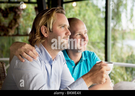 Due uomini guardando fuori dalla finestra Foto Stock